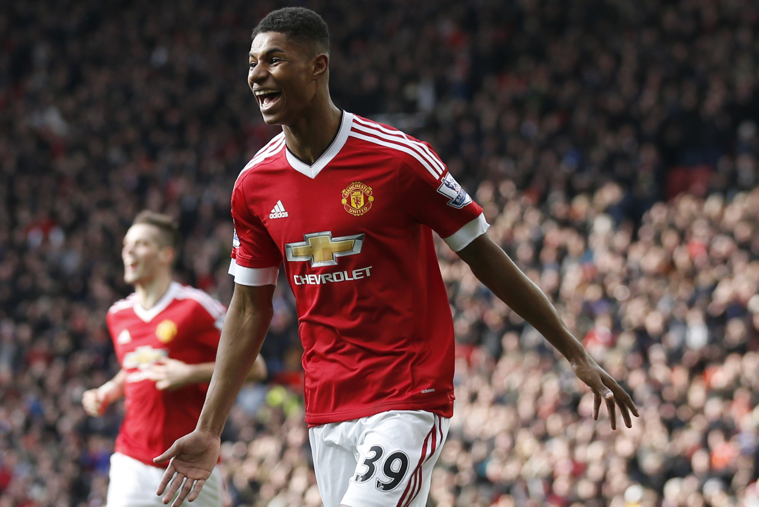 Manchester United's Marcus Rashford, runs to celebrate with teammates after scoring his sides second goal of the game during the English Premier League soccer match between Manchester United and Arsenal at Old Trafford Stadium, Manchester, England, Sunday, Feb. 28, 2016. (AP Photo/Jon Super)