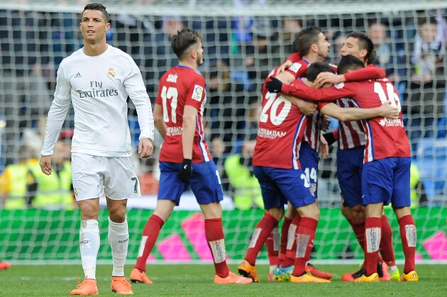 MADRID, SPAIN - FEBRUARY 27: Cristiano Ronaldo of Real Madrid walks away from celebrating Atletico Madrid players after Atletico beat Real 1-0 in the La Liga match between Real Madrid CF and Club Atletico de Madrid at Estadio Santiago Bernabeu on February 27, 2016 in Madrid, Spain. (Photo by Denis Doyle/Getty Images) MADRID, SPAIN - FEBRUARY 27: Cristiano Ronaldo of Real Madrid walks away from celebrating Atletico Madrid players after Atletico beat Real 1-0 in the La Liga match between Real Madrid CF and Club Atletico de Madrid at Estadio Santiago Bernabeu on February 27, 2016 in Madrid, Spain. (Photo by Denis Doyle/Getty Images)