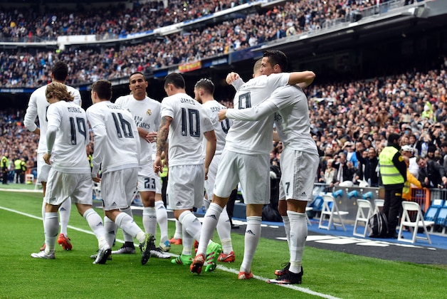 Real Madrid's Portuguese forward Cristiano Ronaldo (R) is congratulated by Real Madrid's French forward Karim Benzema during the Spanish league football match Real Madrid CF vs Athletic Club Bilbao at the Santiago Bernabeu stadium in Madrid on February 13, 2016. / AFP / GERARD JULIEN        (Photo credit should read GERARD JULIEN/AFP/Getty Images)