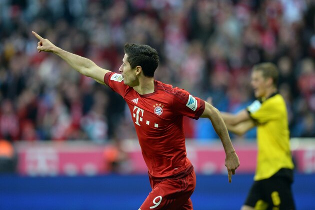 Bayern Munich's Polish striker Robert Lewandowski celebrates after he scores the second goal for Munich during the German first division Bundesliga football match FC Bayern Munich vs Borussia Dortmund in Munich, southern Germany, on October 4, 2015.  AFP PHOTO / CHRISTOF STACHE   RESTRICTIONS: DURING MATCH TIME: DFL RULES TO LIMIT THE ONLINE USAGE TO 15 PICTURES PER MATCH AND FORBID IMAGE SEQUENCES TO SIMULATE VIDEO.  == RESTRICTED TO EDITORIAL USE == FOR FURTHER QUERIES PLEASE CONTACT DFL DIRECTLY AT + 49 69 650050.        (Photo credit should read CHRISTOF STACHE/AFP/Getty Images)