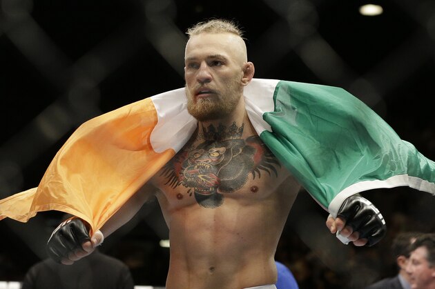 Connor McGregor celebrates after defeating Dustin Poirier in their featherweight mixed martial arts bout at UFC 178 on Saturday, Sept. 27, 2014, in Las Vegas. (AP Photo/John Locher)