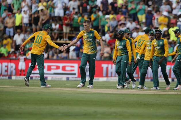 South African bowler Chris Morris (R) celebrates with his teammate David Miller (L) after bowling out England batsman Moen Ali during the second T20 between South Africa and England at Wanderers stadium in Johannesburg on February 21, 2016. / AFP / MARCO LONGARI        (Photo credit should read MARCO LONGARI/AFP/Getty Images)