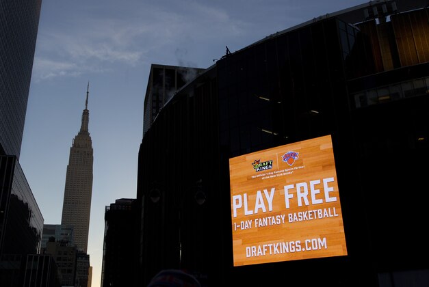 An electronic advertisement for DraftKings hangs on the side of Madison Square Garden, Wednesday, Jan. 6, 2016 in New York. Officials say a court could rule by mid-January in the legal spat between fantasy sports sites FanDuel and DraftKings over a state order to shut down their operations in New York. The companies have asked an appeals court to continue a temporary hold on Attorney General Eric Schneiderman's shutdown order. The companies argue their games are based on skill, not chance, and players pay entry fees in order to manage rosters like a general manager. But Schneiderman has countered that the games are highly dependent on factors out of their control, such as injuries or even the weather, and are thus ultimately based on chance. (AP Photo/Mark Lennihan)