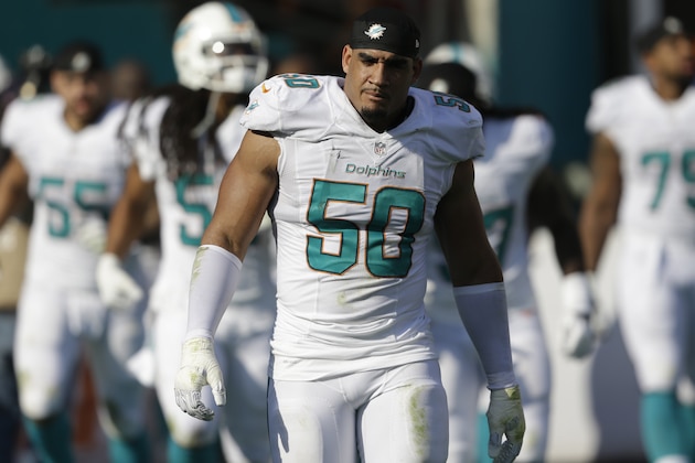 Miami Dolphins defensive end Olivier Vernon (50) walks the sidelines during the second half of an NFL football game against the Miami Dolphins, Sunday, Dec. 7, 2014, in Miami Gardens, Fla. (AP Photo/Wilfredo Lee)
