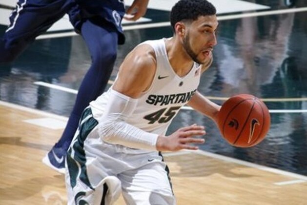 Michigan State's Denzel Valentine brings the ball up court against Penn State during the first half of an NCAA college basketball game, Sunday, Feb. 28, 2016, in East Lansing, Mich. Michigan State won 88-57. (AP Photo/Al Goldis)
