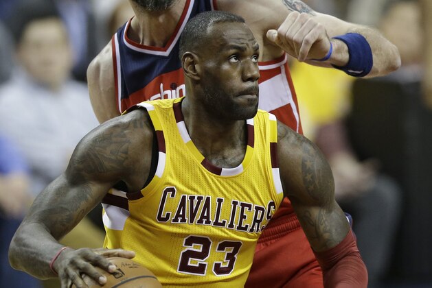 Cleveland Cavaliers' LeBron James (23) drives past Washington Wizards' Marcin Gortat (13), from Poland, in the first half of an NBA basketball game Friday, March 4, 2016, in Cleveland. (AP Photo/Tony Dejak)