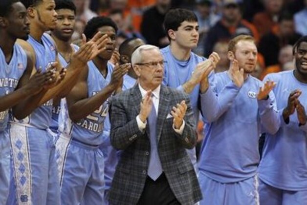 FILE - In this Jan. 9, 2016, file photo, North Carolina head coach Roy Williams claps with players on the bench during the second half of an NCAA college basketball game against Syracuse in Syracuse, N.Y. No. 2 North Carolina is the only unbeaten team in the Atlantic Coast Conference after a favorable opening month of the league schedule. The Tar Heels on Saturday play Boston College, which is 0-7 in the league. Then things get tougher.  (AP Photo/Nick Lisi, File)