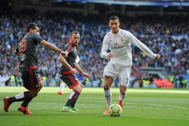 MADRID, SPAIN - MARCH 05:  Cristiano Ronaldo of Real Madrid is challenged by  Jonny Castro Otto of Celta Vigo during the La Liga match between Real Madrid CF and Celta Vigo at Estadio Santiago Bernabeu on March 5, 2016 in Madrid, Spain.  (Photo by Denis Doyle/Getty Images)