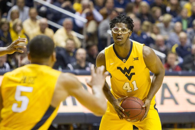 Mar 2, 2016; Morgantown, WV, USA; West Virginia Mountaineers forward Devin Williams (41) passes to guard Jaysean Paige (5) during the second half against the Texas Tech Red Raiders at the WVU Coliseum. Mandatory Credit: Ben Queen-USA TODAY Sports
