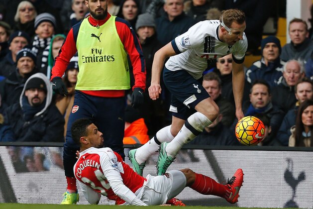 Tottenham Hotspur's English striker Harry Kane is foulded by Arsenal's French midfielder Francis Coquelin (L) which leads to  Francis Coquelin receiving a second yellow card during the English Premier League football match between Tottenham Hotspur and Arsenal at White Hart Lane in London, on March 5, 2016. / AFP / IKIMAGES / IKimages / RESTRICTED TO EDITORIAL USE. No use with unauthorized audio, video, data, fixture lists, club/league logos or 'live' services. Online in-match use limited to 45 images, no video emulation. No use in betting, games or single club/league/player publications.        (Photo credit should read IKIMAGES/AFP/Getty Images)