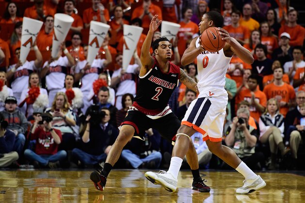 CHARLOTTESVILLE, VA - MARCH 05:  Devon Hall #0 of the Virginia Cavaliers handles the ball against Quentin Snider #2 of the Louisville Cardinals in the first half during their game at John Paul Jones Arena on March 5, 2016 in Charlottesville, Virginia.  (Photo by Patrick McDermott/Getty Images)