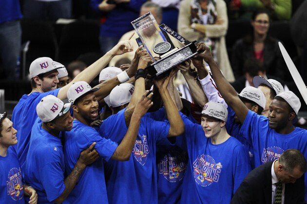 The Kansas Jayhawks celebrate winning an NCAA college basketball game and the final of the Big 12 men's basketball tournament against Texas in Kansas City, Mo., Saturday, March 12, 2011. Kansas defeated Texas 85-73. (AP Photo/Orlin Wagner)
