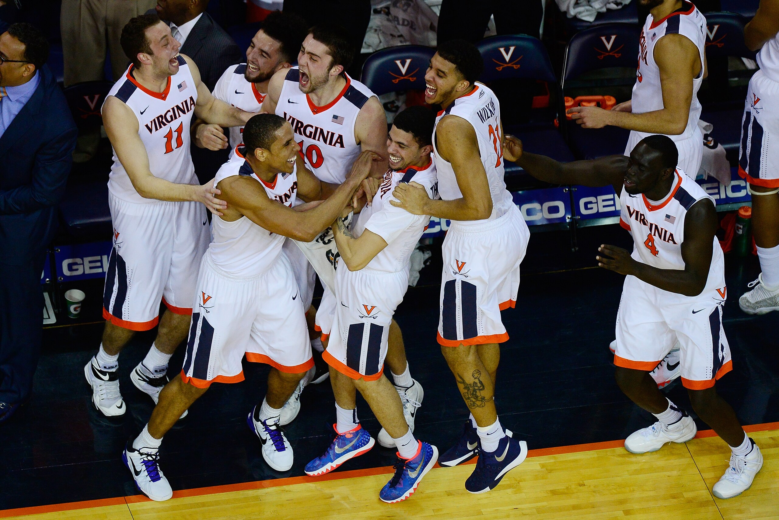 CHARLOTTESVILLE, VA - MARCH 05:  Malcolm Brogdon #15 of the Virginia Cavaliers celebrates with his teammates after Caid Kirven #24 (not pictured) made a three-point field goal in the second half during their game against the Louisville Cardinals at John Paul Jones Arena on March 5, 2016 in Charlottesville, Virginia.  (Photo by Patrick McDermott/Getty Images)