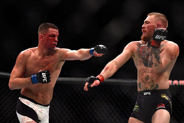 LAS VEGAS, NV - MARCH 05: (L-R) Nate Diaz punches Conor McGregor of Ireland during the UFC 196 event inside MGM Grand Garden Arena on March 5, 2016 in Las Vegas, Nevada.  (Photo by Jeff Bottari/Zuffa LLC/Zuffa LLC via Getty Images)