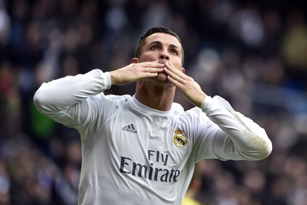 Real Madrid's Portuguese forward Cristiano Ronaldo celebrates after making it a hat trick by scoring his third goal during the Spanish league football match Real Madrid CF vs RC Celta de Vigo at the Santiago Bernabeu stadium in Madrid on March 5, 2016. / AFP / GERARD JULIEN        (Photo credit should read GERARD JULIEN/AFP/Getty Images)