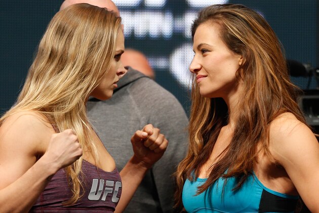 LAS VEGAS, NV - DECEMBER 27:  (L-R) Opponents Ronda Rousey and Miesha Tate face off during the UFC 168 weigh-in at the MGM Grand Garden Arena on December 27, 2013 in Las Vegas, Nevada. (Photo by Josh Hedges/Zuffa LLC/Zuffa LLC via Getty Images)