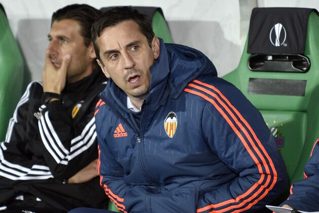 Valencia's head coach Gary Neville sits during the UEFA Europa League, Round of 32 match football between Rapid Wien and Valencia in Vienna, Austria on February 25, 2016.  / AFP / HANS PUNZ        (Photo credit should read HANS PUNZ/AFP/Getty Images)