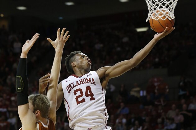 Oklahoma guard Buddy Hield (24) shoots behind Texas forward Connor Lammert, left, in the second half of an NCAA college basketball game in Norman, Okla., Monday, Feb. 8, 2016. Oklahoma won 63-60. (AP Photo/Sue Ogrocki)