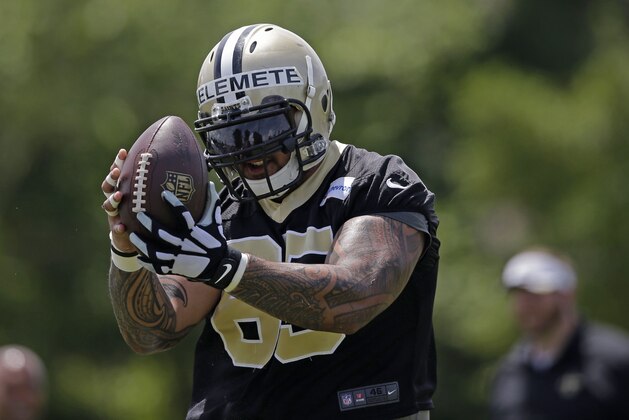 New Orleans Saints guard Senio Kelemete (65)  pulls in a pass during mini camp at their NFL football training facility in Metairie, La., Thursday, June 18, 2015. (AP Photo/Gerald Herbert)