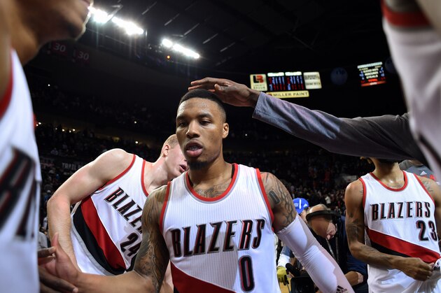 Feb 23, 2016; Portland, OR, USA; Portland Trail Blazers guard Damian Lillard (0) celebrates with teammates after defeating the Brooklyn Nets 112-104 at Moda Center at the Rose Quarter. Lillard finished the game with 34 points. Mandatory Credit: Godofredo Vasquez-USA TODAY Sports