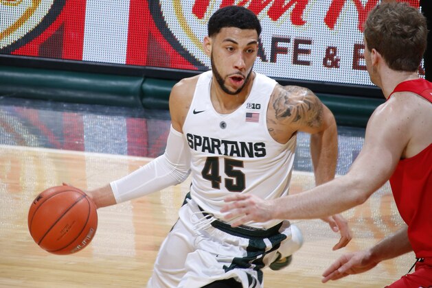 Michigan State's Denzel Valentine (45) drives against Ohio State's Mickey Mitchell during the first half of an NCAA college basketball game, Saturday, March 5, 2016, in East Lansing, Mich. (AP Photo/Al Goldis)