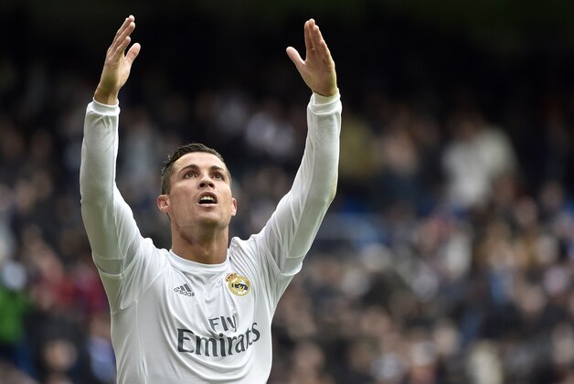 Real Madrid's Portuguese forward Cristiano Ronaldo celebrates after making it a hat trick by scoring his third goal during the Spanish league football match Real Madrid CF vs RC Celta de Vigo at the Santiago Bernabeu stadium in Madrid on March 5, 2016. / AFP / GERARD JULIEN        (Photo credit should read GERARD JULIEN/AFP/Getty Images)