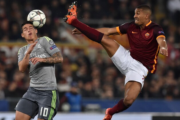 ROME, ITALY - FEBRUARY 17:  James Rodriguez of Real Madrid CF and William Vainqueur of AS Roma in action during the UEFA Champions League Round of 16 First Leg match between AS Roma and Real Madrid CF at Stadio Olimpico on February 17, 2016 in Rome, Italy.  (Photo by Giuseppe Bellini/Getty Images)
