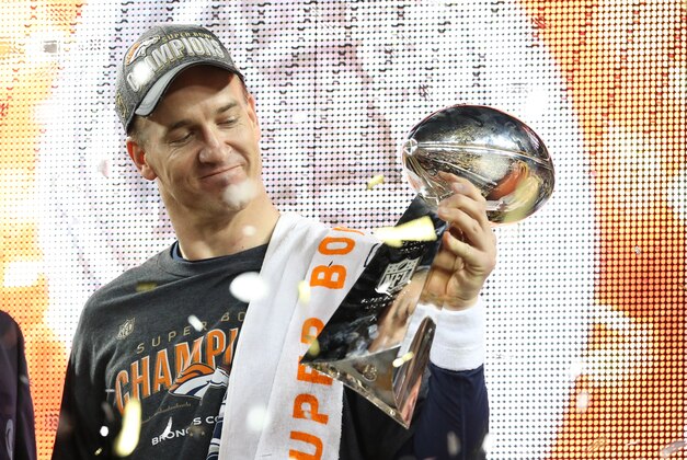 Feb 7, 2016; Santa Clara, CA, USA; Denver Broncos quarterback Peyton Manning (18) looks at the Vince Lombardi Trophy after beating the Carolina Panthers in Super Bowl 50 at Levi's Stadium. Mandatory Credit: Matthew Emmons-USA TODAY Sports