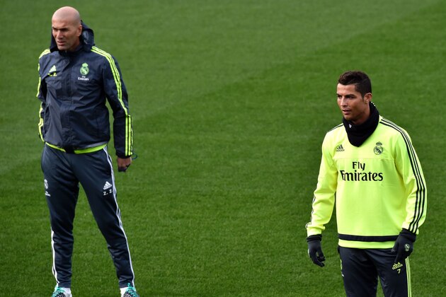 Real Madrid's new French coach Zinedine Zidane (L) and Real Madrid's Portuguese forward Cristiano Ronaldo take part in a training session at the Valdebebas training ground in Madrid on January 8, 2016.   AFP PHOTO / GERARD JULIEN / AFP / GERARD JULIEN        (Photo credit should read GERARD JULIEN/AFP/Getty Images)