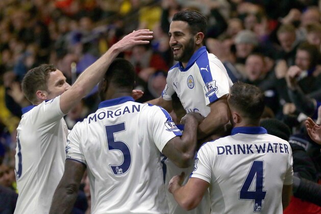 Leicester’s Riyad Mahrez is lifted by his teammates as he celebrates after scoring a goal during the English Premier League soccer match between Watford and Leicester City at the Vicarage Road stadium in London, Saturday, March 5, 2016. (AP Photo/Tim Ireland)