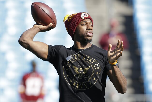 Washington Redskins' Robert Griffin III warms up before an NFL football game against the Carolina Panthers in Charlotte, N.C., Sunday, Nov. 22, 2015. (AP Photo/Bob Leverone)