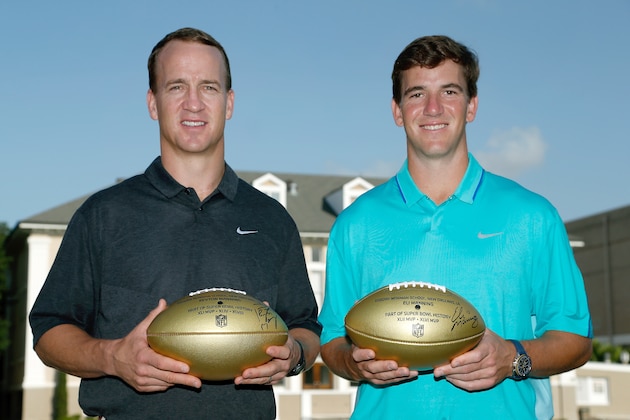 IMAGE DISTRIBUTED FOR NATIONAL FOOTBALL LEAGUE - In this photo released by the NFL, Denver Broncos quarterback Peyton Manning, left, and New York Giants quarterback Eli Manning pose for a photo during a visit to Isidore Newman School in New Orleans on Thursday, July 9, 2015. (Jonathan Bachman/AP Images for National Football League)