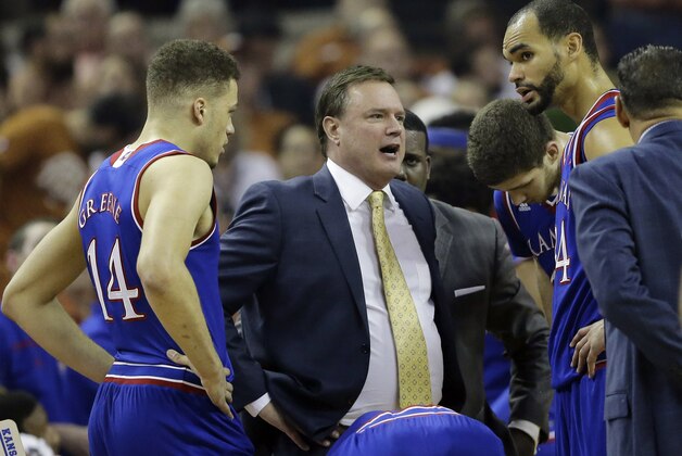 Kansas head coach Bill Self, center, talks to his players during the first half of an NCAA college basketball game against Texas, Monday, Feb. 29, 2016, in Austin, Texas. (AP Photo/Eric Gay)