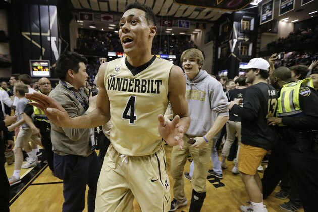 Vanderbilt guard Wade Baldwin IV (4) makes his way through fans who ran onto the court after Vanderbilt upset No. 16 Kentucky 74-62 in an NCAA college basketball game Saturday, Feb. 27, 2016, in Nashville, Tenn. (AP Photo/Mark Humphrey)