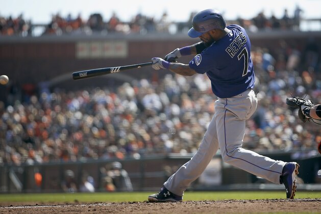 Colorado Rockies' Jose Reyes (7) hits a single against the San Francisco Giants during the third inning of a baseball game, Sunday, Oct. 4, 2015, in San Francisco. (AP Photo/Tony Avelar)
