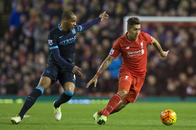 Liverpool's Roberto Firmino, rigth, fights for the ball against Manchester City's Fernando during the English Premier League soccer match between Liverpool and Manchester City at Anfield Stadium, Liverpool, England, Wednesday, March 2, 2016. (AP Photo/Jon Super)