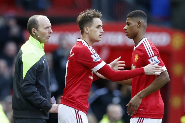 Manchester United's Marcus Rashford, right is substituted by teammate Adnan Januzaj during the English Premier League soccer match between Manchester United and Arsenal at Old Trafford Stadium, Manchester, England, Sunday, Feb. 28, 2016. (AP Photo/Jon Super)