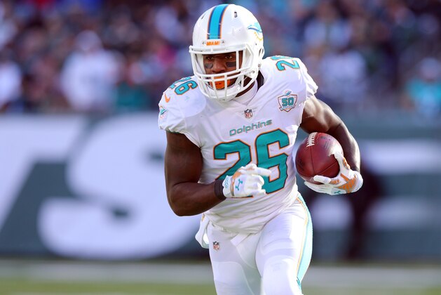 Miami Dolphins running back Lamar Miller (26) runs with the ball against the New York Jets during an NFL game at MetLife Stadium in East Rutherford, N.J. on Sunday, Nov. 29, 2015. (AP Photo/Brad Penner)