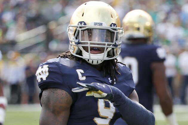 In this Saturday, Sept. 26, 2015 photo, Notre Dame linebacker Jaylon Smith reacts to the crowd after making a tackle during the first half of an NCAA college football game against  Massachusetts, in South Bend, Ind. Jaylon Smith is hard to keep track of. Sometimes he lines up at weakside linebacker spot and rushes the passer. Other times he lines up in the same spot and drops back in coverage. Other times he slides out to play strongside linebacker. Still other times he lines up at defensive end. (AP Photo/Charles Rex Arbogast)