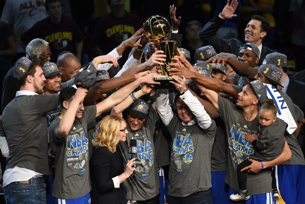 Golden State Warriors celebrate after defeating the Cleveland Cavaliers in Game 6 to win the 2015 NBA Finals June 16, 2015 at the at Quicken Loans Arena in Cleveland, Ohio. Steph Curry and Andre Iguodala each scored 25 points as the Golden State Warriors captured their first NBA title in 40 years by defeating Cleveland 105-97 to win the NBA Finals.  AFP PHOTO  / TIMOTHY A. CLARY        (Photo credit should read TIMOTHY A. CLARY/AFP/Getty Images)