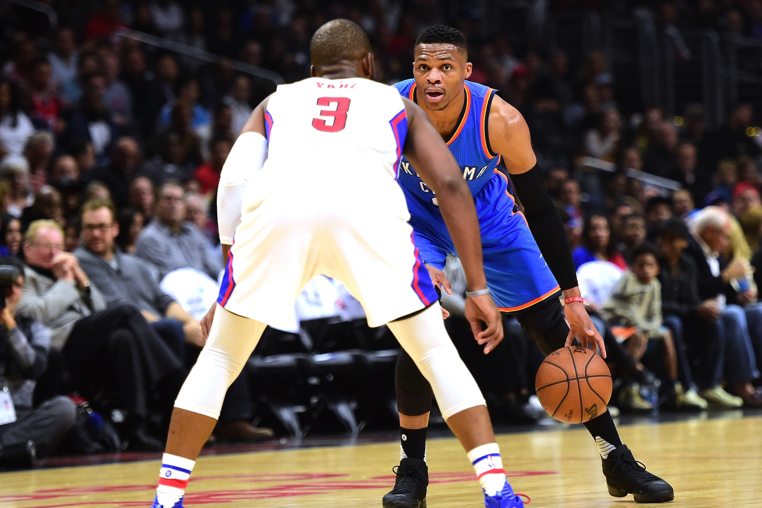 LOS ANGELES, CA - DECEMBER 21:  Russell Westbrook #0 of the Oklahoma City Thunder dribbles as he is guarded by Chris Paul #3 of the Los Angeles Clippers at Staples Center on December 21, 2015 in Los Angeles, California.  NOTE TO USER: User expressly acknowledges and agrees that, by downloading and or using this Photograph, user is consenting to the terms and condition of the Getty Images License Agreement.  (Photo by Harry How/Getty Images)
