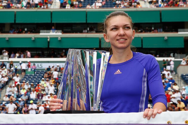 INDIAN WELLS, CA - MARCH 22:  Simona Halep of Romania with the winners trophy after defeating Jelena Jankovic of Serbia in the final during day fourteen of the BNP Paribas Open tennis at the Indian Wells Tennis Garden on March 22, 2015 in Indian Wells, California.  (Photo by Julian Finney/Getty Images)