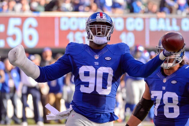 Dec 6, 2015; East Rutherford, NJ, USA; New York Giants defensive end Jason Pierre-Paul (90) celebrates after recovering a fumble during the first half against the New York Jets at MetLife Stadium. Mandatory Credit: Robert Deutsch-USA TODAY Sports