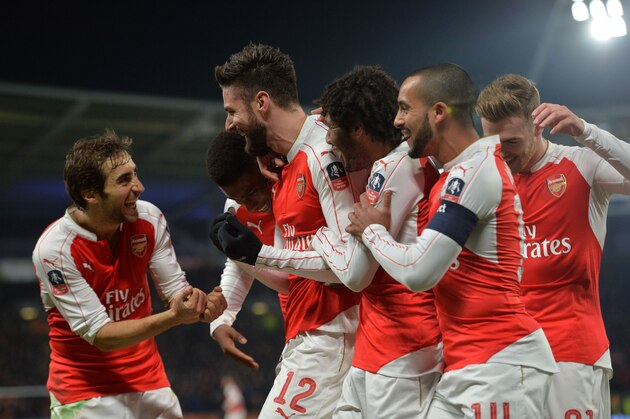 Arsenal's French striker Olivier Giroud (3rd L) celebrates with teammates after scoring the opening goal of the English FA cup fifth round replay football match between Hull City and Arsenal at the KC Stadium in Kingston upon Hull in north east England on March 8, 2016.  / AFP / Paul ELLIS / RESTRICTED TO EDITORIAL USE. No use with unauthorized audio, video, data, fixture lists, club/league logos or 'live' services. Online in-match use limited to 75 images, no video emulation. No use in betting, games or single club/league/player publications.  /         (Photo credit should read PAUL ELLIS/AFP/Getty Images)