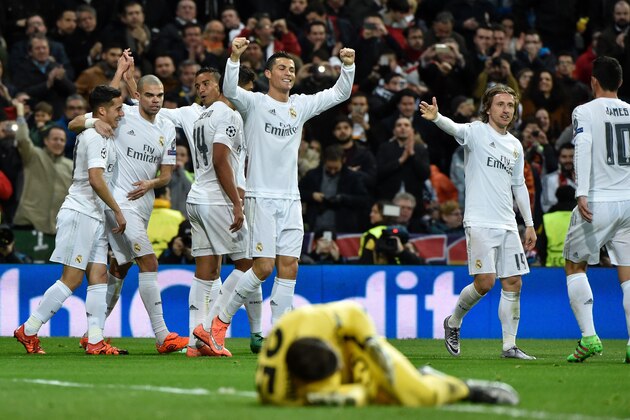 Real Madrid's Portuguese forward Cristiano Ronaldo (C) celebrates after scoring during the UEFA Champions League round of 16, second leg football match Real Madrid FC vs AS Roma at the Santiago Bernabeu stadium in Madrid on March 8, 2016. / AFP / GERARD JULIEN        (Photo credit should read GERARD JULIEN/AFP/Getty Images)