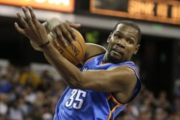 Oklahoma City Thunder forward Kevin Durant, left, grabs a rebound against Sacramento Kings guard Rajon Rondo during the second half of an NBA basketball game  Monday, Feb. 29, 2016, in Sacramento, Calif.  The Thunder won 131-116. (AP Photo/Rich Pedroncelli)