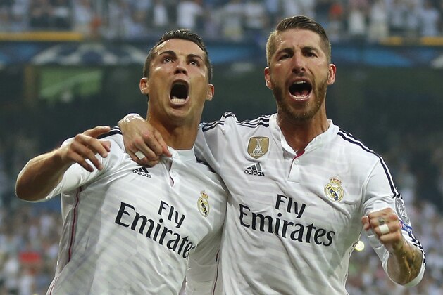 Real Madrid's Cristiano Ronaldo and teammate Sergio Ramos, right, celebrate after Ronaldo scored 1-0 during the Champions League second leg semifinal soccer match between Real Madrid and Juventus, at the Santiago Bernabeu stadium in Madrid, Wednesday, May 13, 2015. (AP Photo/Daniel Ochoa de Olza)