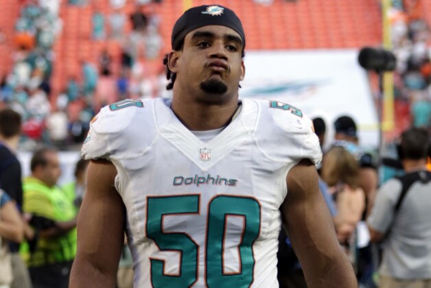 Miami Dolphins defensive end Olivier Vernon (50) walks off the field after an NFL football game against the Carolina Panthers, Sunday, Nov. 24, 2013, in Miami Gardens, Fla. (AP Photo/Alan Diaz)