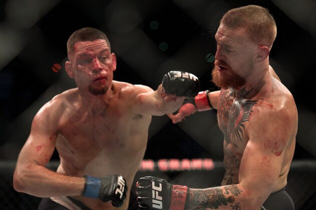 LAS VEGAS, NV - MARCH 5:   (L-R) Nate Diaz punches Conor McGregor in their welterweight bout during the UFC 196 in the MGM Grand Garden Arena on March 5, 2016 in Las Vegas, Nevada. (Photo by Brandon Magnus/Zuffa LLC/Zuffa LLC via Getty Images)
