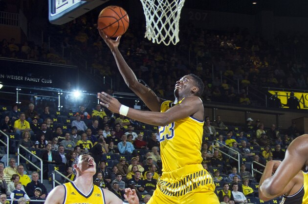 Michigan guard Caris LeVert (23) makes a basket, watched by forward Ricky Doyle (32), in the first half of an NCAA college basketball game against Bryant at Crisler Center in Ann Arbor, Mich., Wednesday, Dec. 23, 2015. (AP Photo/Tony Ding)